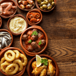 Spanish tapas: squid, chicken wings, meatballs, olives, etc.